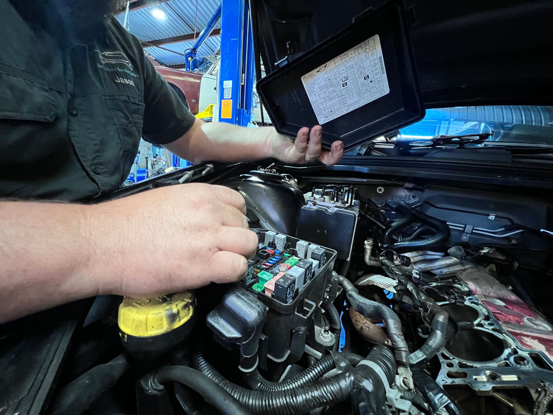 Close-up of a mechanic providing a logbook service at Joe's Auto Service Centre Forster